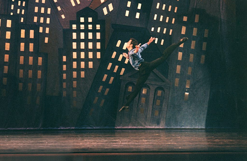 A male ballet dancer in a city scene.