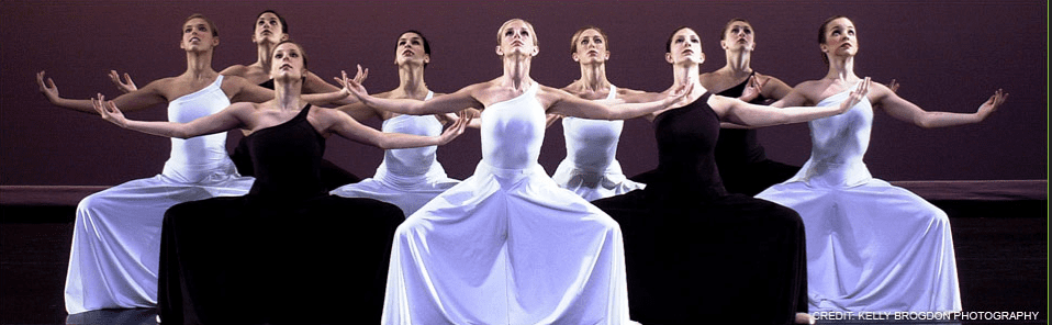 A group of dancers with their arms outstretched.