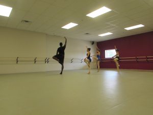 A group of dancers in a dance studio.