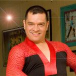 A man in a red and black outfit posing for a photo.