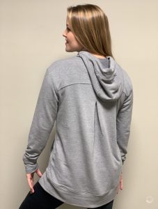 The back view of a woman wearing a grey hoodie.