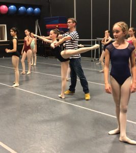 A group of young dancers in a ballet class.