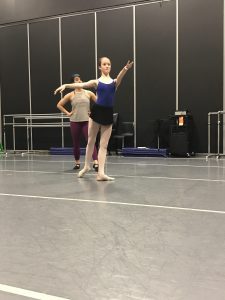 Two female ballet dancers practicing in a dance studio.