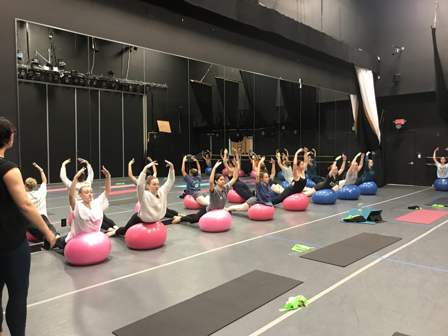 A group of people doing yoga in a gym.